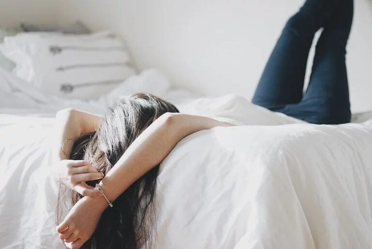 woman laying on bed