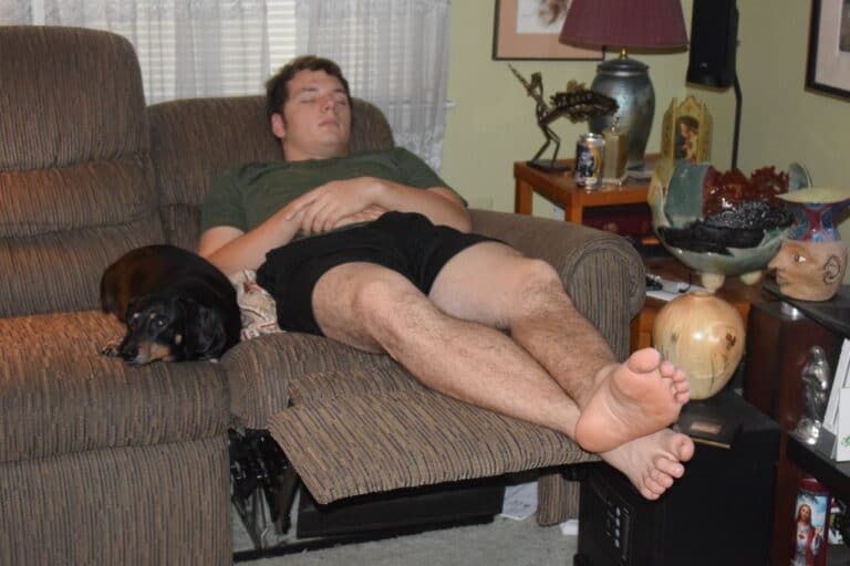 man sleeping beside dog