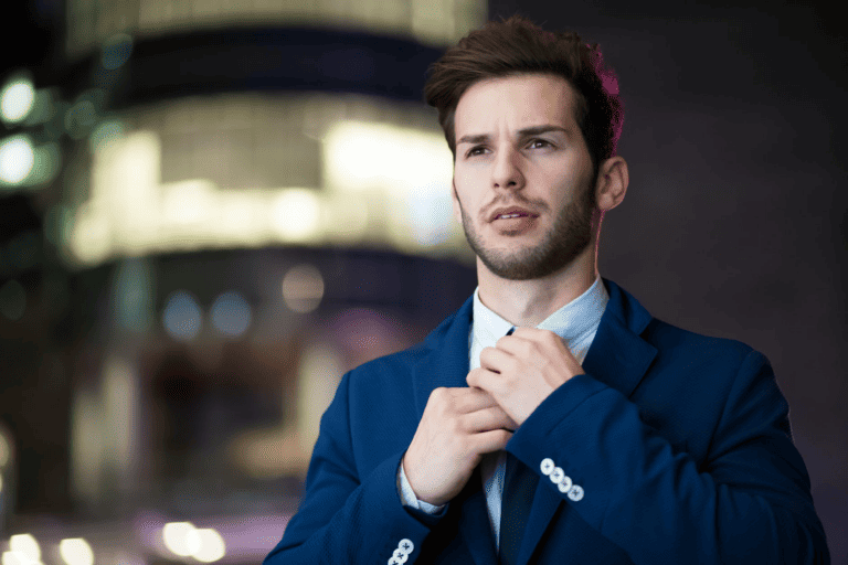 man adjusting tie