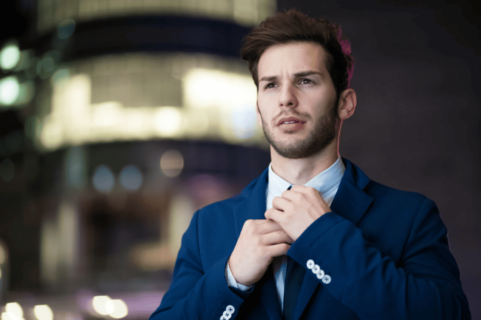 How To Get Ahead In Your Career Without Killing Yourself In The Process 2 man adjusting tie