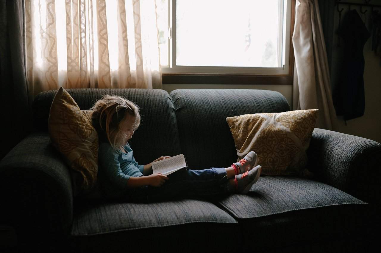child reading on couch