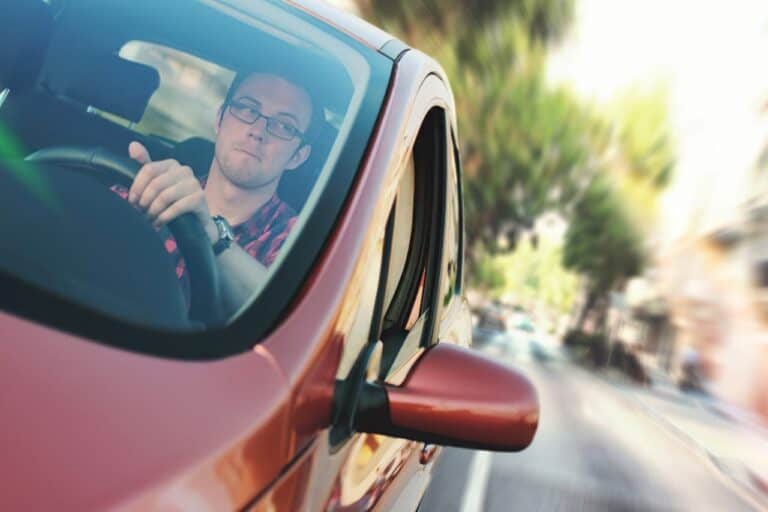 man driving down the street