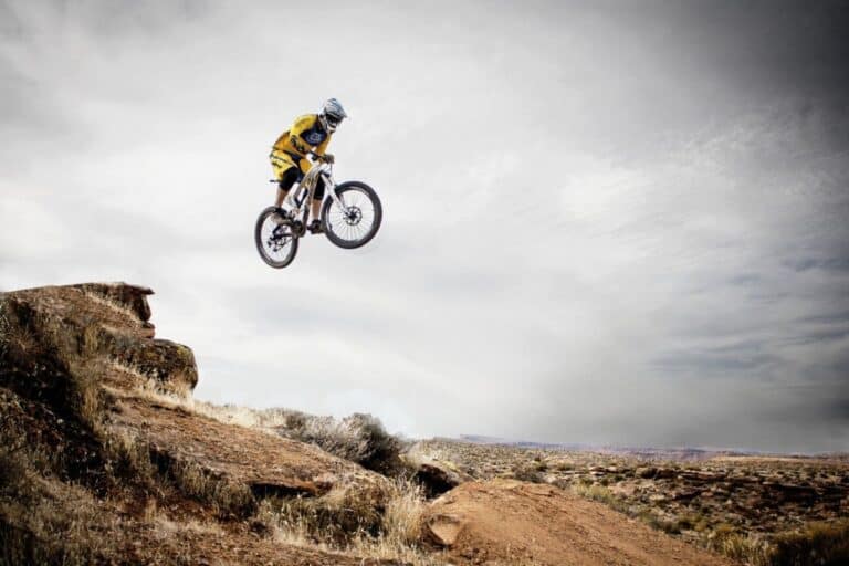 mountain biker jumping over rocks
