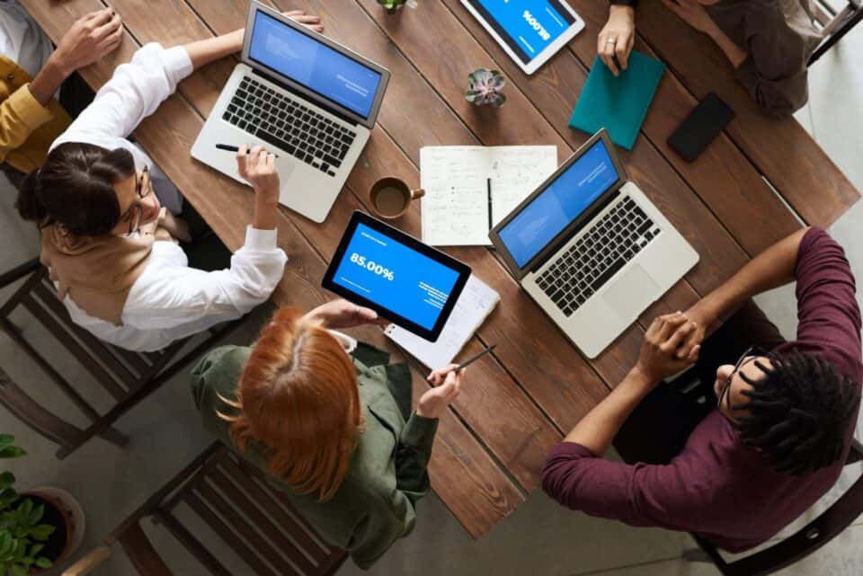 Is Your Business Performance Reaching Its Max Potential? Let's Find Out 3 people on computers