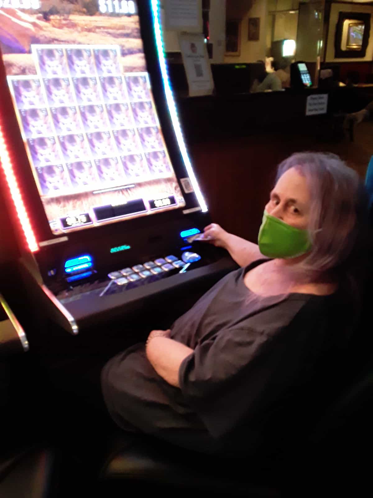 old woman using slot machine