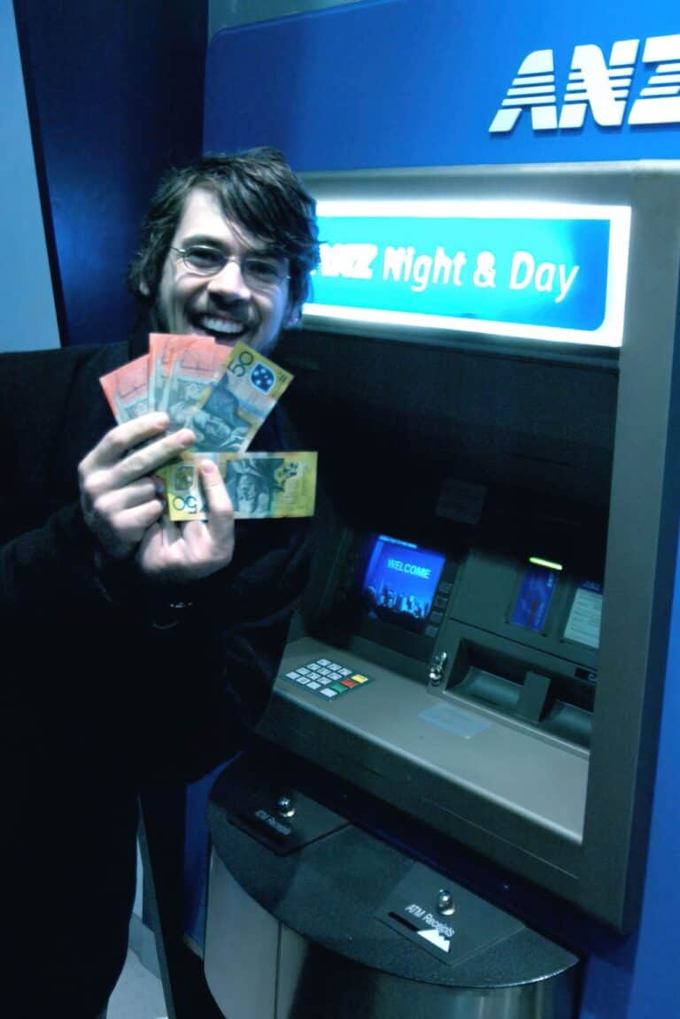 man holding cash smiling