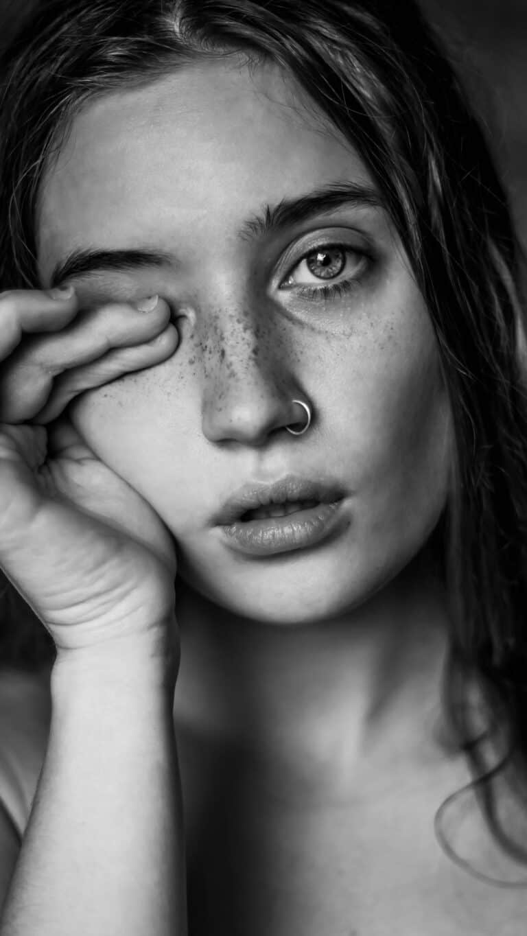 woman rubbing eyes