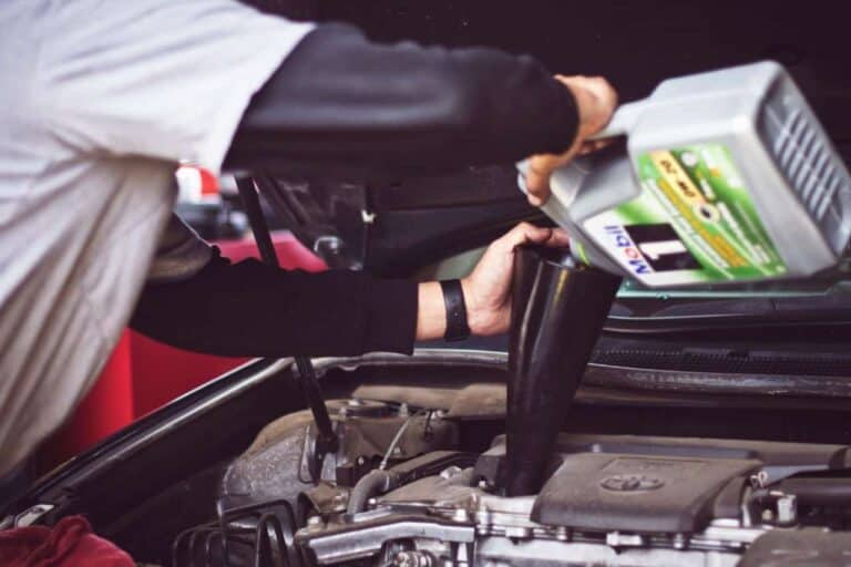 pouring oil into car