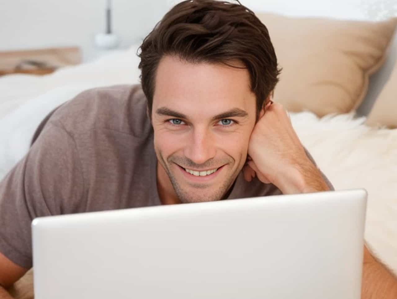 man smiling with laptop