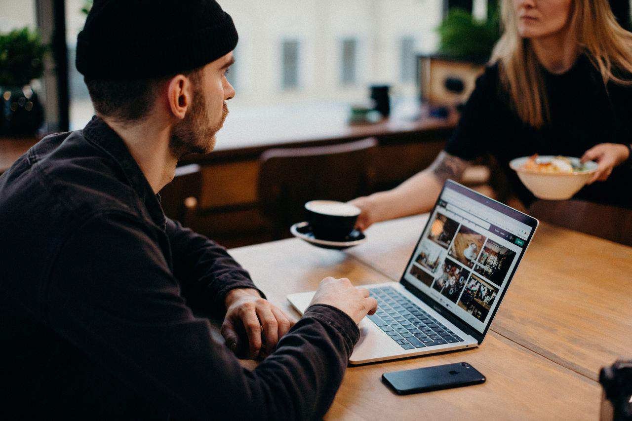 a man working from his laptop at a coffee shop