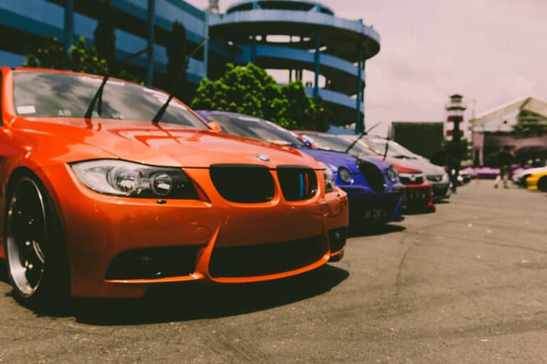 bmw cars lined up in a parking lot
