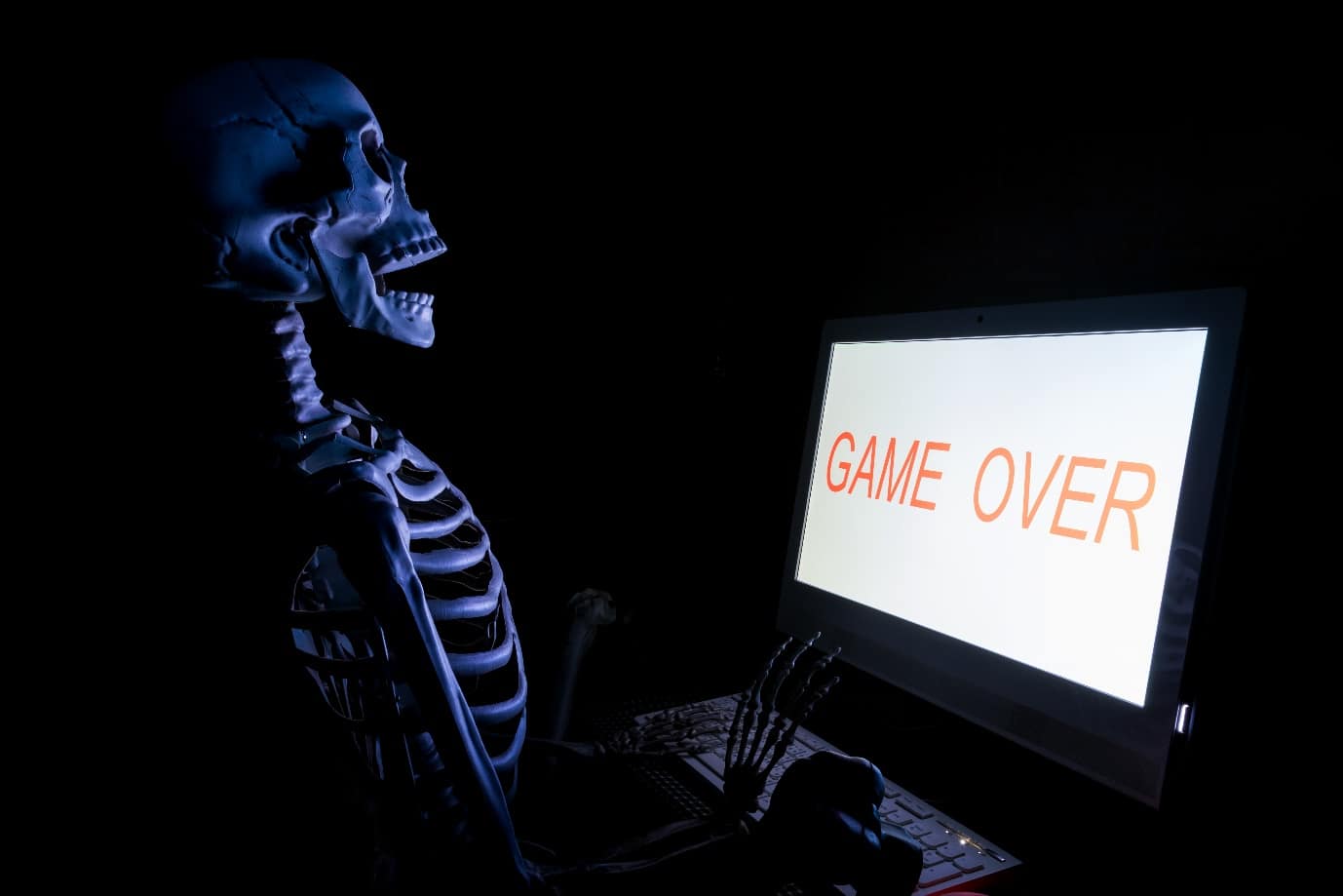 skeleton and game over on computer screen