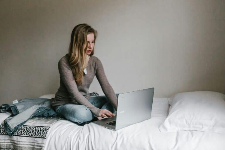 woman working on laptop side hustle