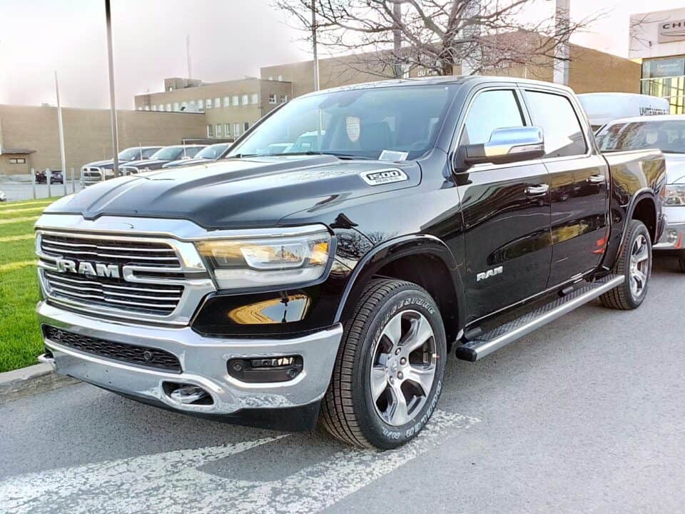 A middle-aged man thoughtfully adjusts the climate control in the luxurious interior of a Ram 1500 truck. Ram 1500 1