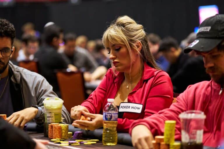 Poker tournament women playing poker at table with chips and drinks, focused on game, social gambling event, poker entertainment, casino night, competitive poker atmosphere.