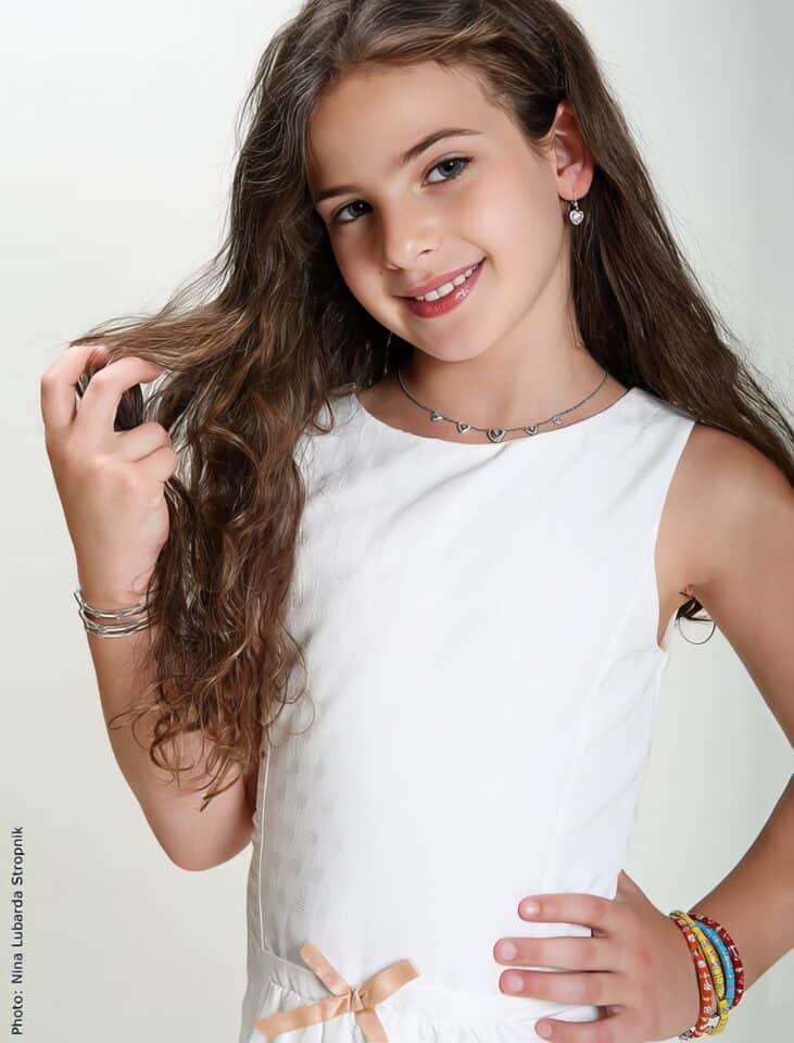 Benefits of Non-Toxic Jewelry for Kids: 7 Safe & Healthy Reasons 8 Elegant girl wearing jewelry and a white dress, smiling for a portrait, showcasing fashion accessories and beauty tips, perfect for lifestyle and jewelry blog content.