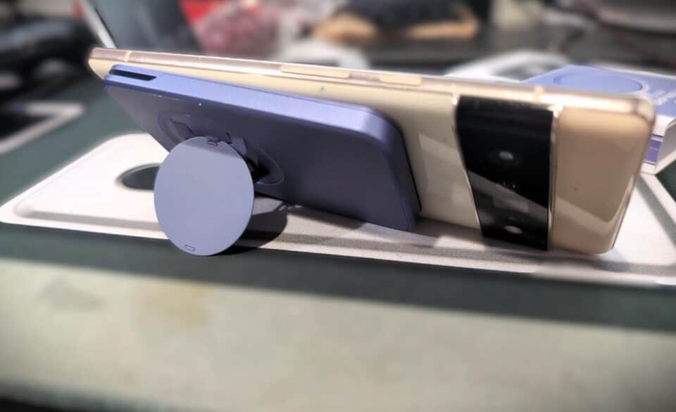 Wireless charging pad with smartphone on a desk, demonstrating convenient mobile device charging technology.
