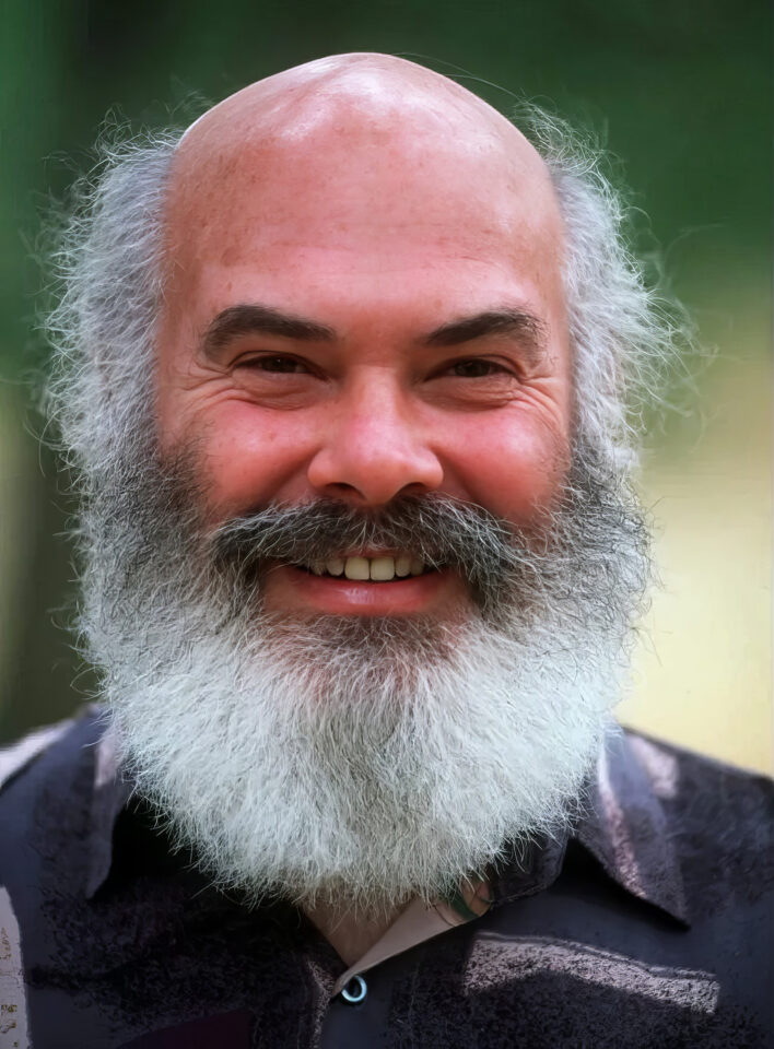 Spontaneous Happiness Book Review: Dr. Andrew Weil's 7 Holistic Paths to Joy 3 A smiling older man with a full white beard and bald head outdoors with blurred green background.