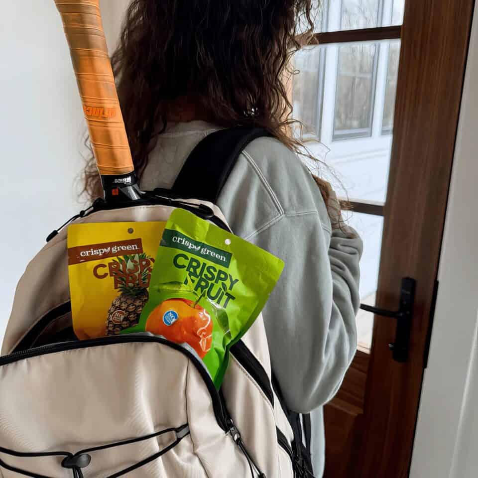 Crispy Green Healthy Habits Monthly Supply Box Review: How Freeze-Dried Fruit Won Over My Picky Eaters 3 Compact backpack with crispy green fruit snacks and pineapple chips.