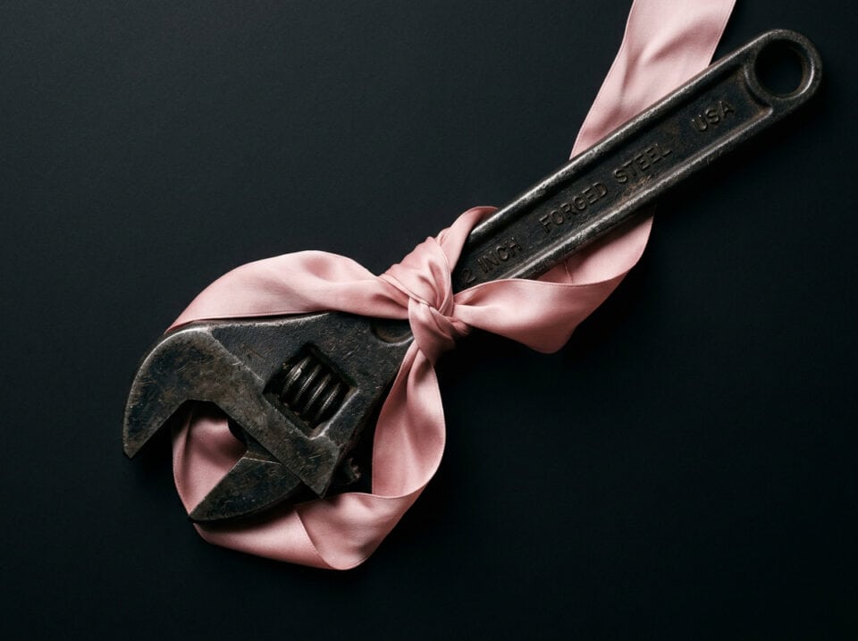 The Happy Wife's Guide to Sissy Husband Lifestyles 2 Wrench tool wrapped in a pink ribbon symbolizing boundaries and relationship advice for couples exploring Sissy Husband dynamics.