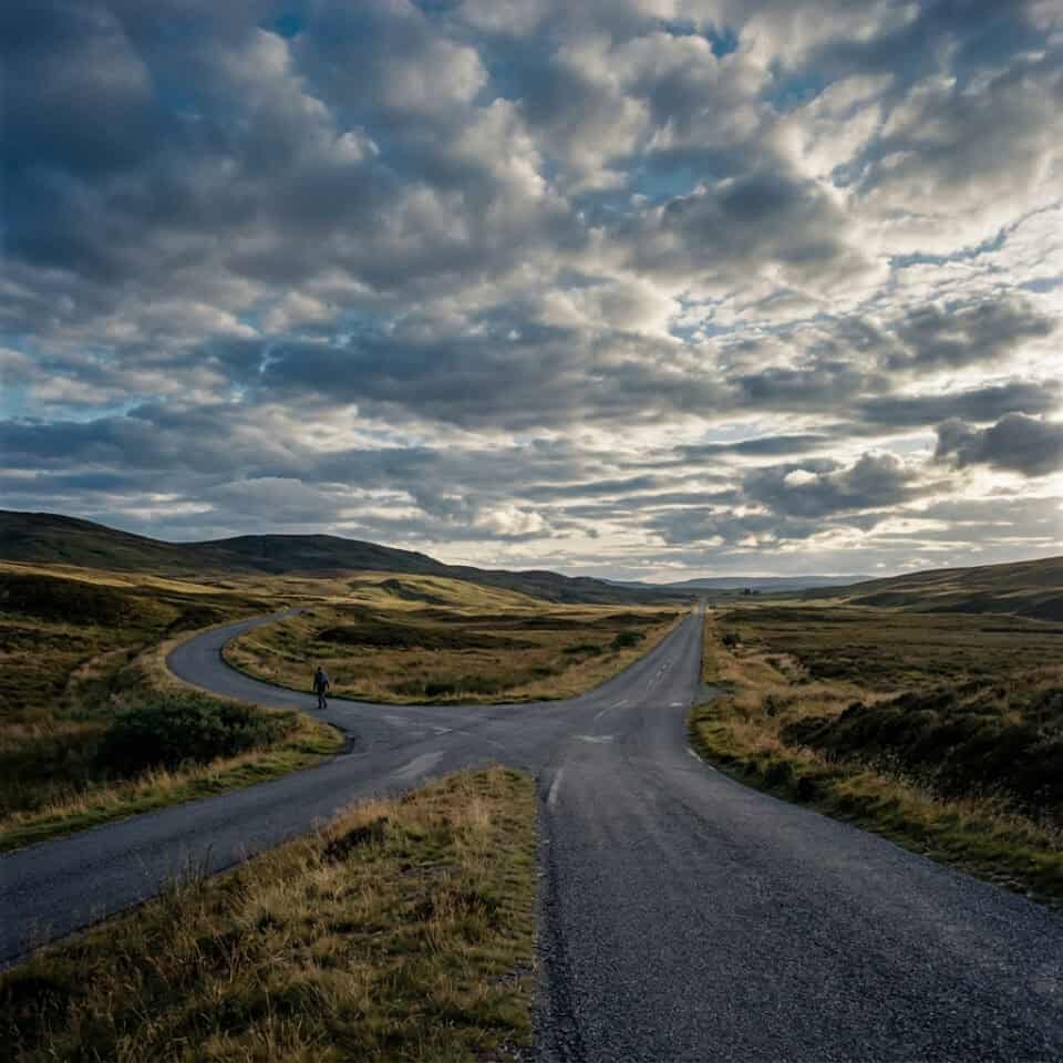 Scenic open road winding through rolling countryside under a dramatic cloudy sky, perfect for travel and adventure photography.
