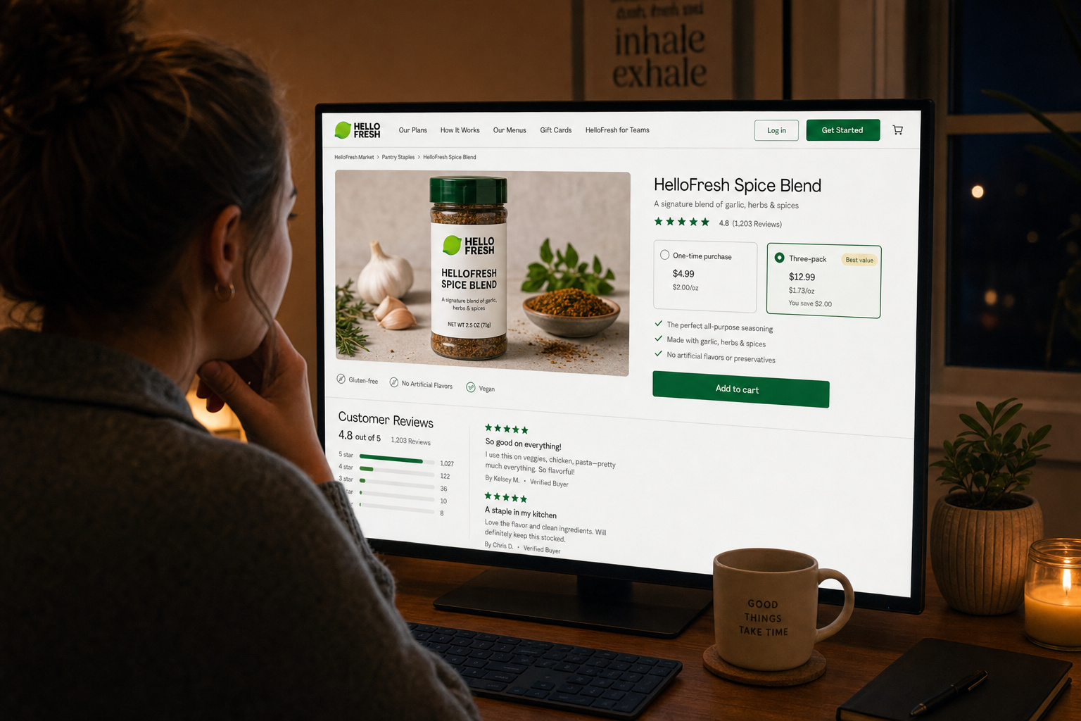 Customer reading HelloFresh spice product reviews on a laptop with a coffee mug
