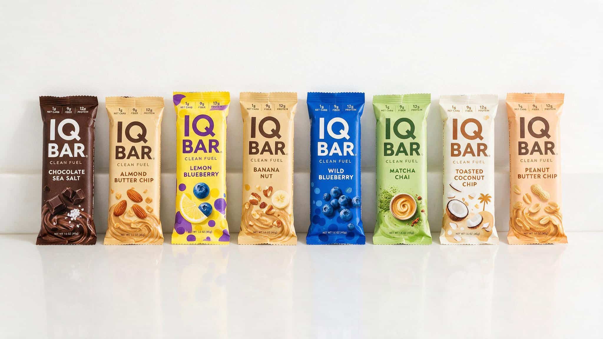 IQ Bar Yuka Score: Why It Scores 51/100 and 75/100 by Flavor 8 All eight IQ Bar flavors arranged in a row: chocolate sea salt, almond butter chip, lemon blueberry, banana nut, wild blueberry, matcha chai, toasted coconut chip, and peanut butter chip.