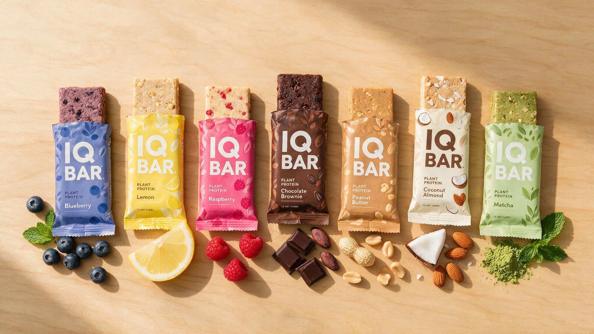 Seven IQBAR flavors arranged in a row, showing the full sampler pack lineup for taste testing.