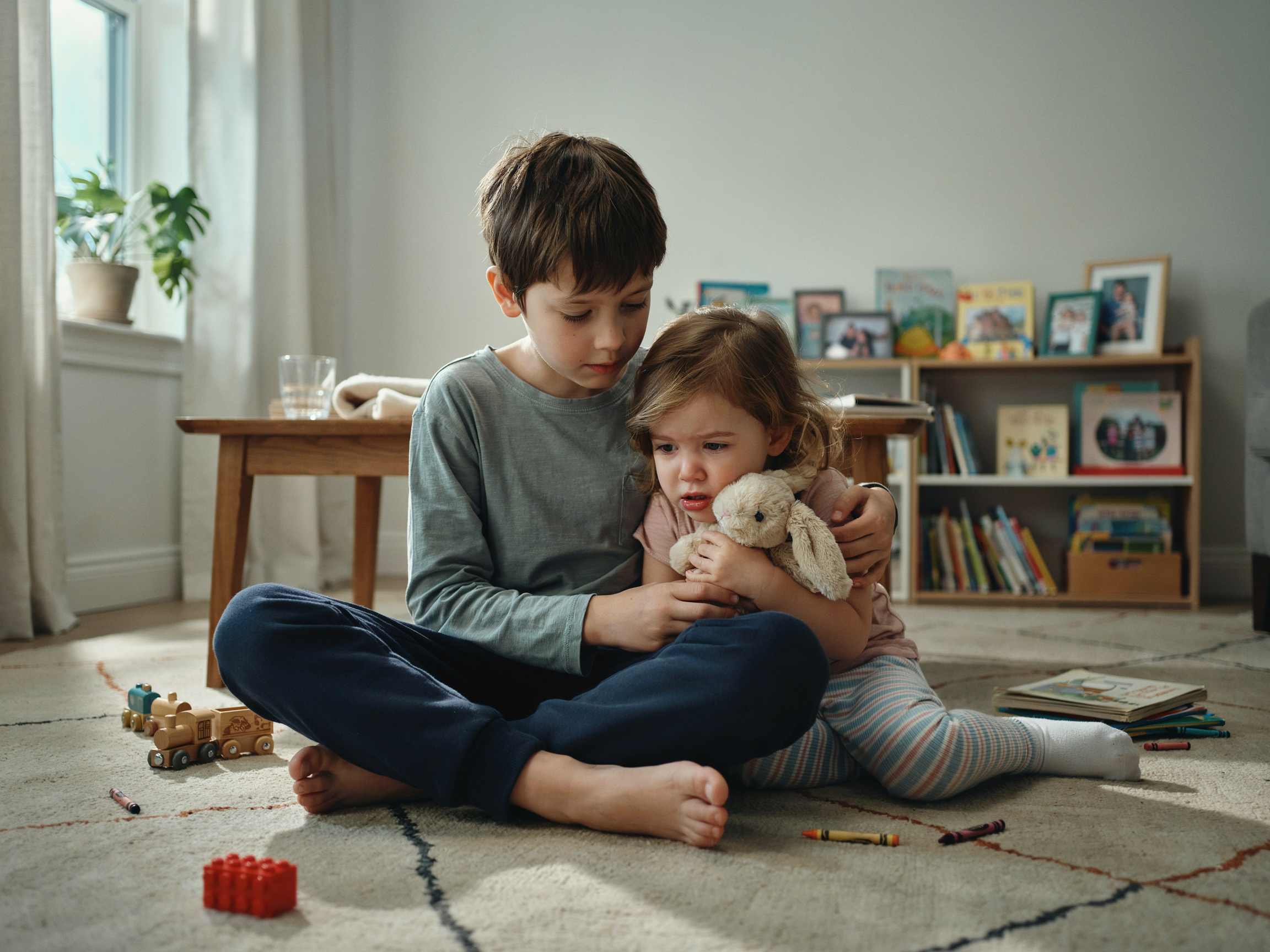 5 Most Important Family Values (Backed by Research, Not Opinion) 6 Siblings showing compassion as one comforts another, illustrating taught kindness in action