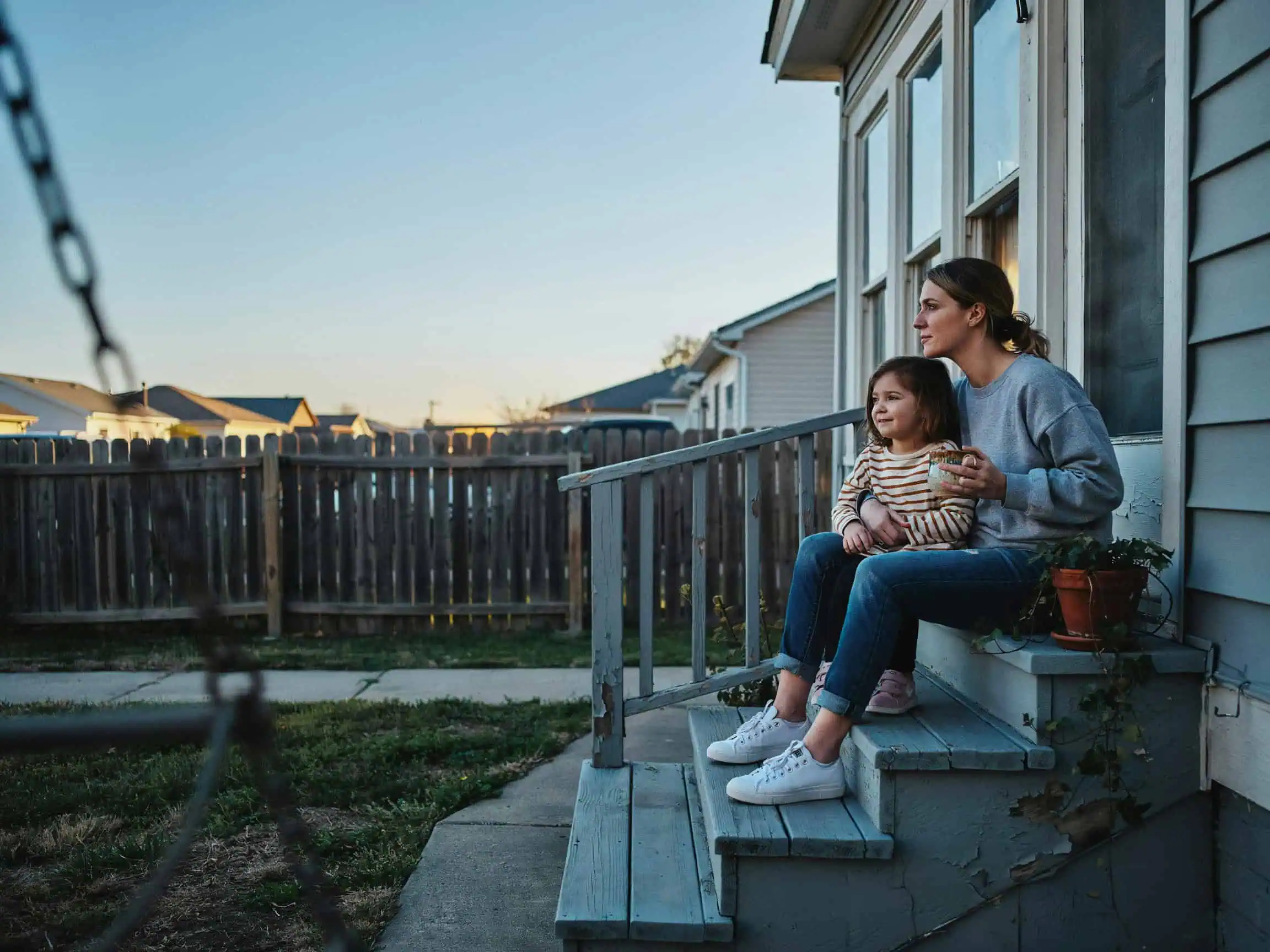 What Is the Value of Family in Sociology? A Data-Driven Look at How Families Transmit Values 2 Single parent and child on porch at sunset, reflecting diverse family structures in modern society.