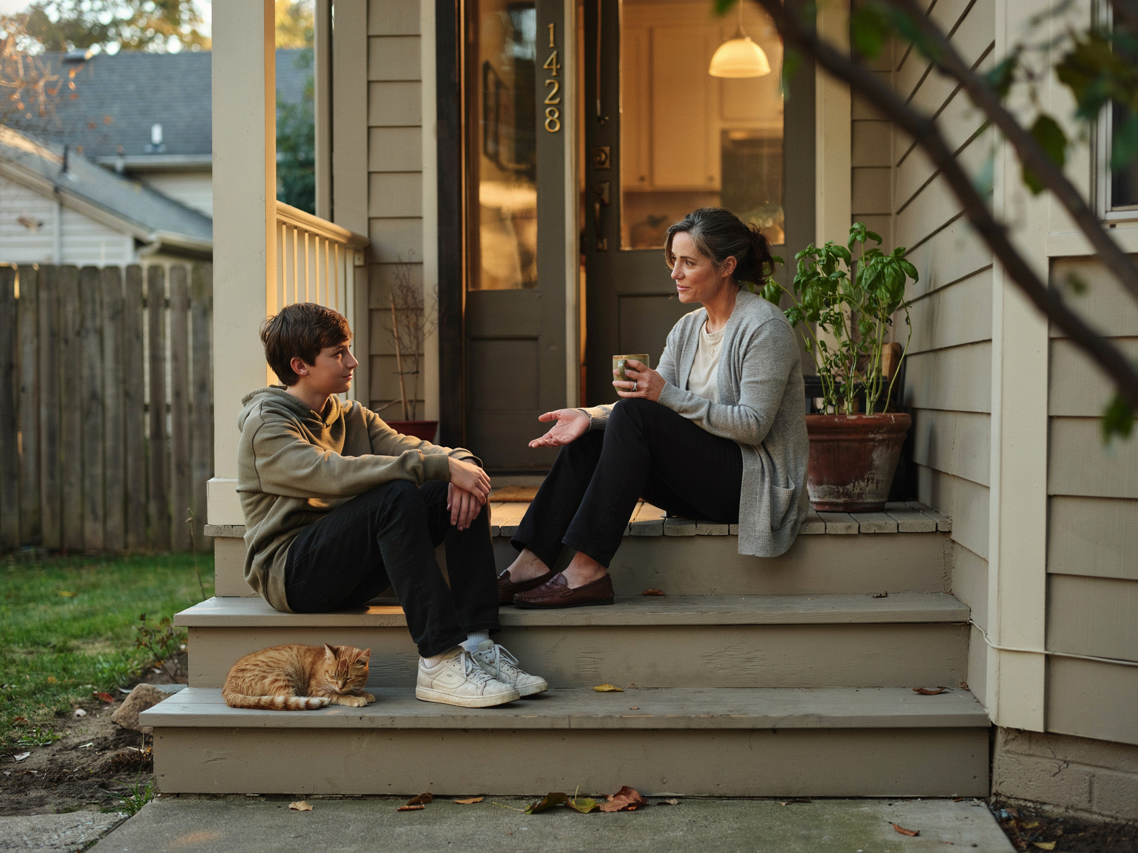 What Is the Value of Family? A Practical Guide to Defining What Matters Most 9 Teenager and parent talking on porch steps, illustrating evolving family values around trust and independence.