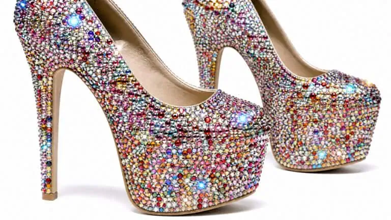 Pair of high-heeled shoes covered in multicolored rhinestones, showcasing a dazzling and glamorous design.