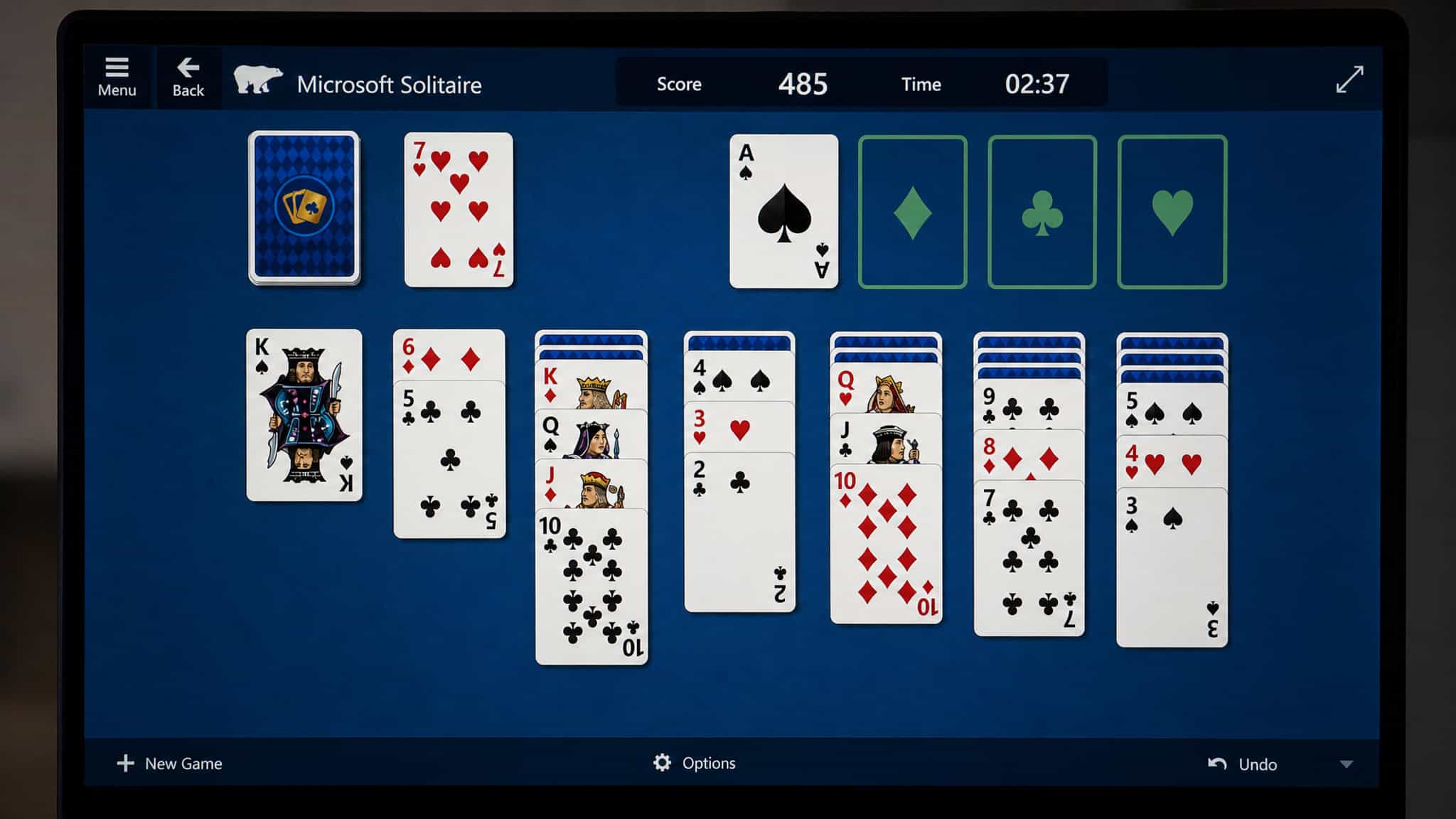 How to Win Solitaire Strategy: Flip Hidden Cards First 4 Microsoft Solitaire game screen with score display, illustrating scoring strategy.