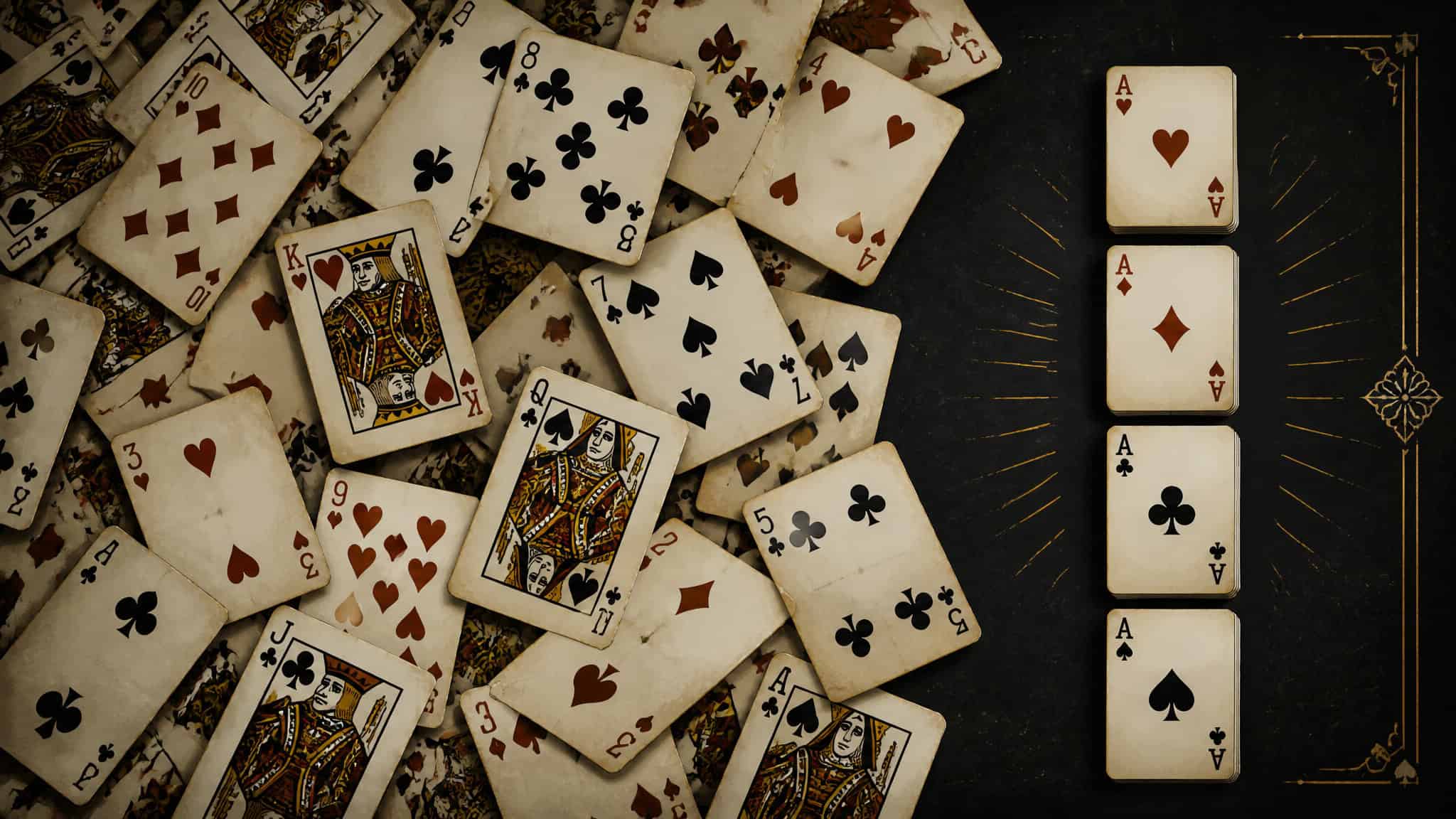 A collection of playing cards, including face cards and numbered cards, spread out on a dark surface, with some cards overlapping each other.