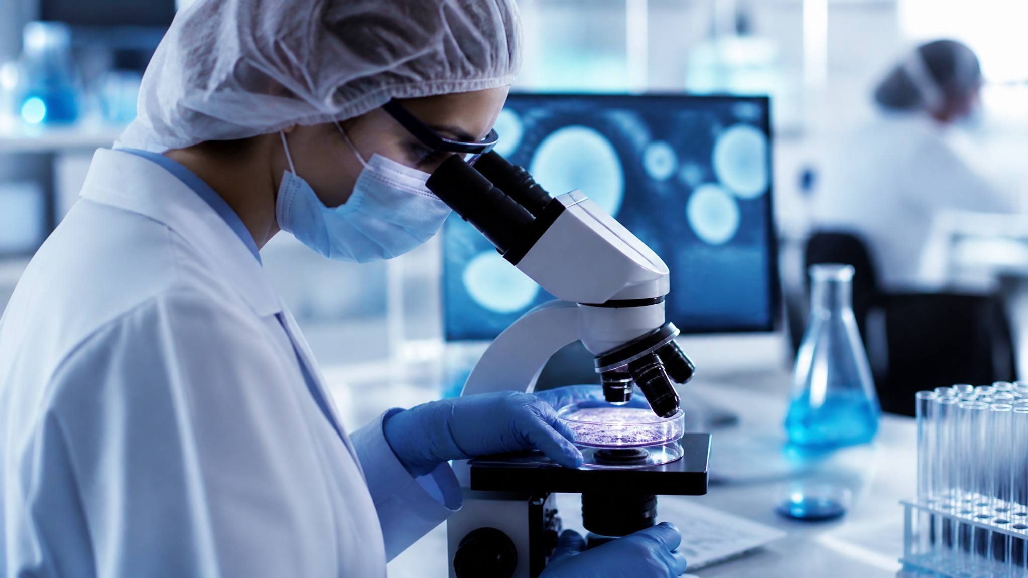 Adonis Ukraine Surrogacy: A Balanced Review of the 3.8-Star Kyiv Clinic 2 Scientist in sterile gear examining a petri dish in Adonis's embryology lab, part of the integrated fertility system.