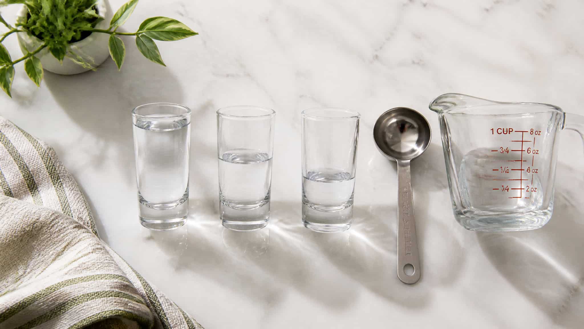 How to Choose Shot Glasses: Why a 2-Oz Glass Holds Only 1.5 3 Comparing 1 oz, 1.5 oz, and 2 oz shot glass sizes with a measuring cup