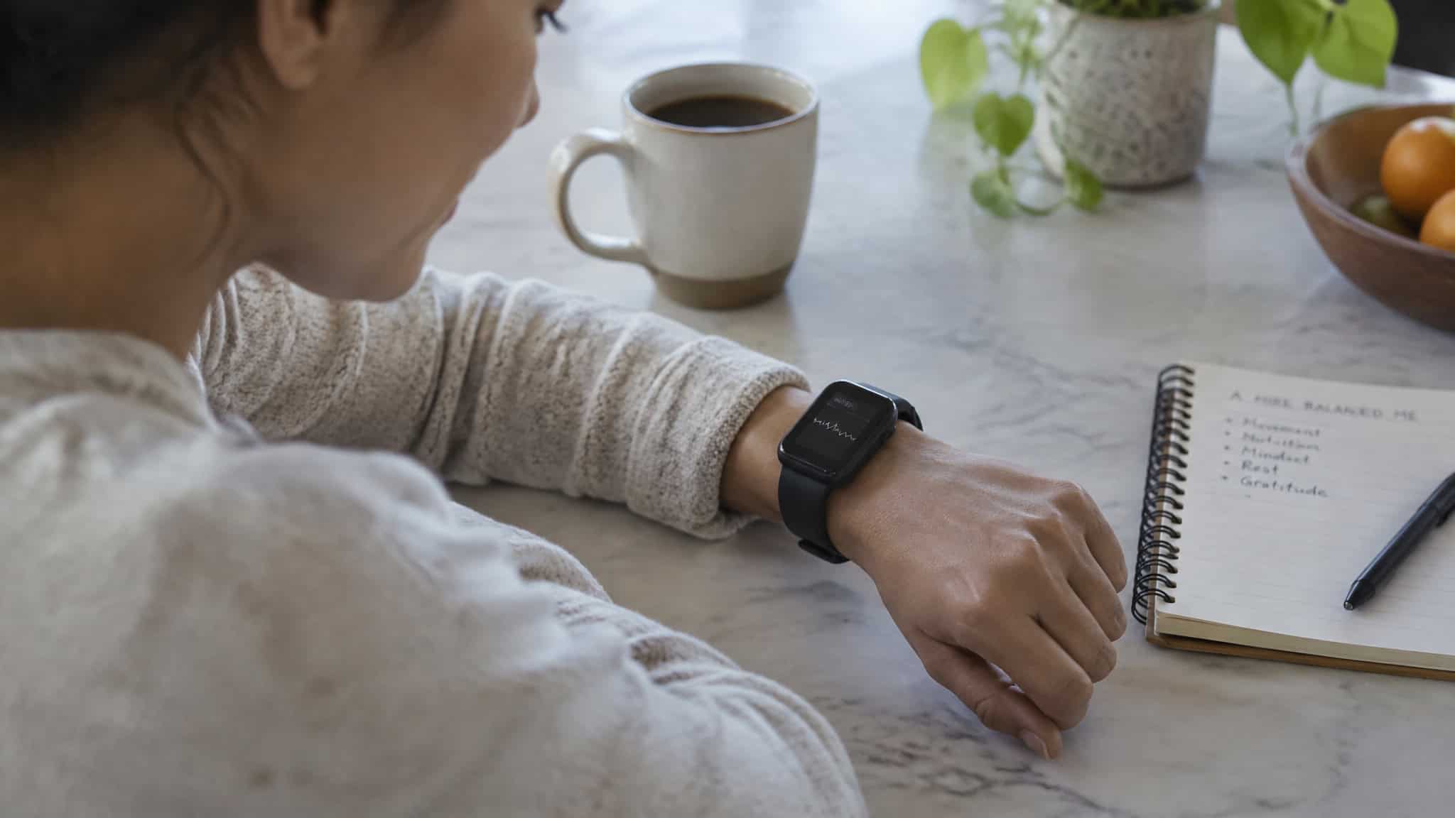 Women Trending Workout Styles for 2026, Ranked by Data — Not TikTok 2 Fitness tracker data on a woman's wrist, illustrating wearable technology trends for weekly workout patterns